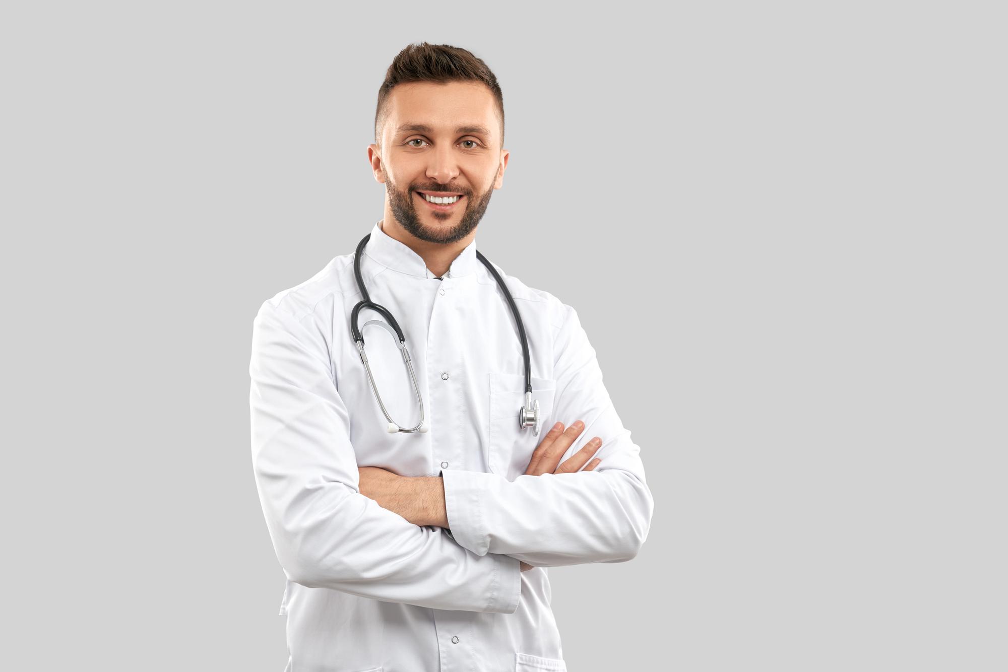 smiling-doctor-with-strethoscope-isolated-grey-1.jpg